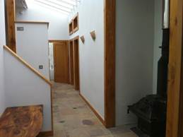 Hallway on lower level with stair to upper level
